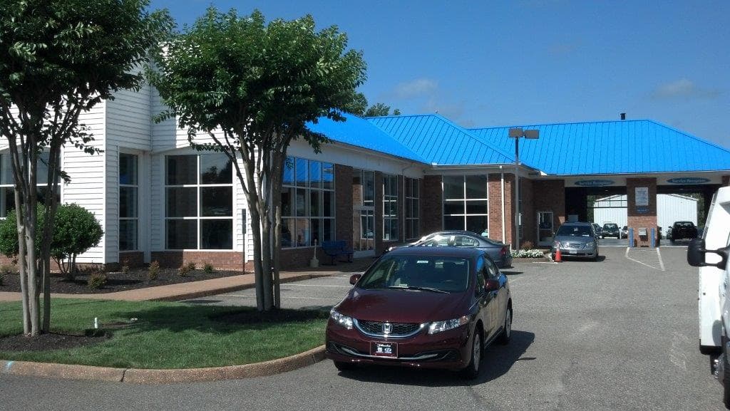 Commercial building with a blue roof and glass storefront