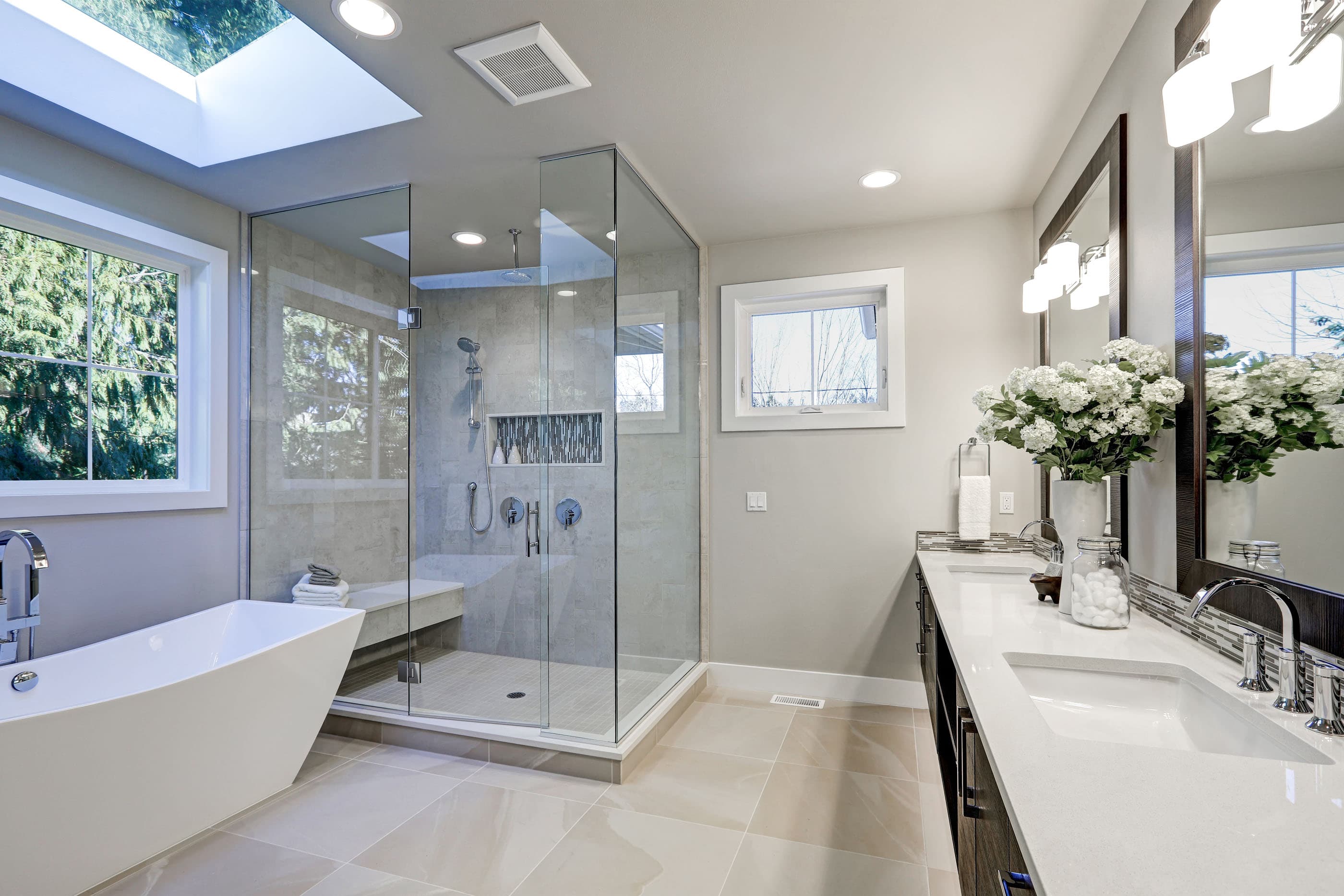 Glass shower enclosure in a bathroom