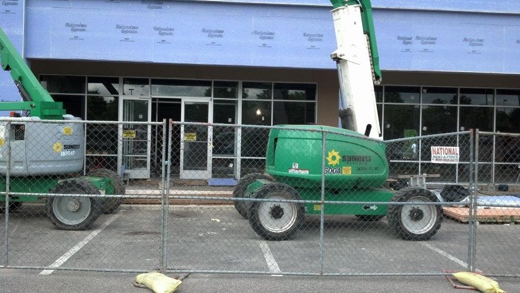 Lift positioned outside a storefront during glass installation